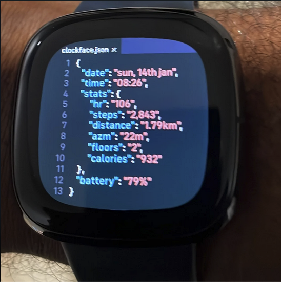 Digital watch with "clockface.json" with items like "date" and "time" and "calories" and "Battery life" all in JSON defined on the watch screen in code.