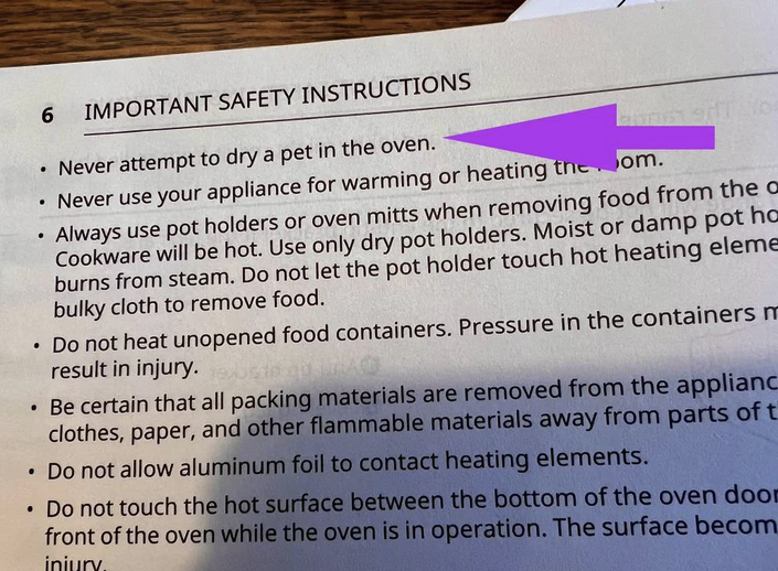 Page from a written manual for a new stove with an arrow pointing to this sentence: "Never attempt to dry a pet in the oven."