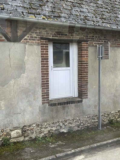 A house with a front door that is about three feet above the street level with no stairs or ramp or anything.