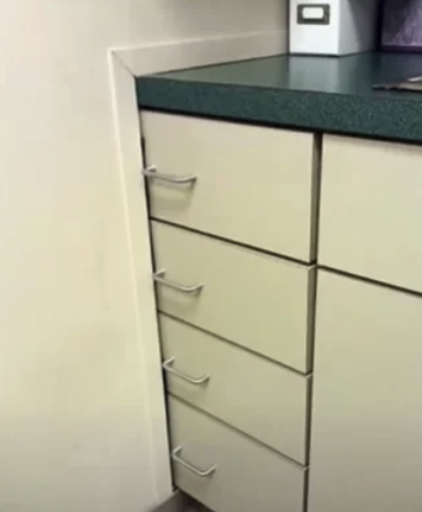 A counter that's about 1 foot into a wall where you can't open the four drawers that are shown on the front of it.