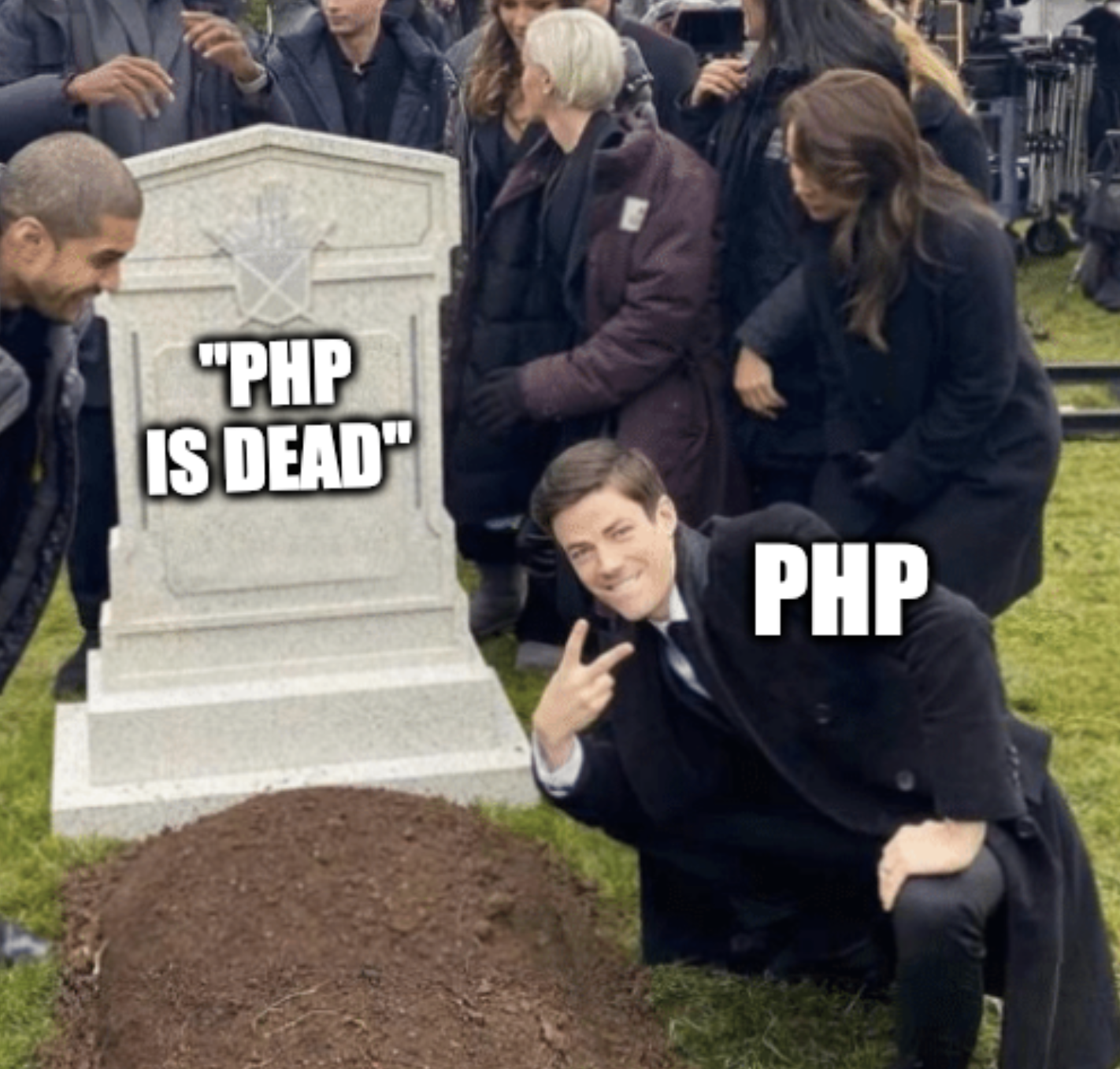 Grant Gustin over grave meme. Grave says "PHP is dead". Grant is hovering of it showing a peace sign representing "PHP".