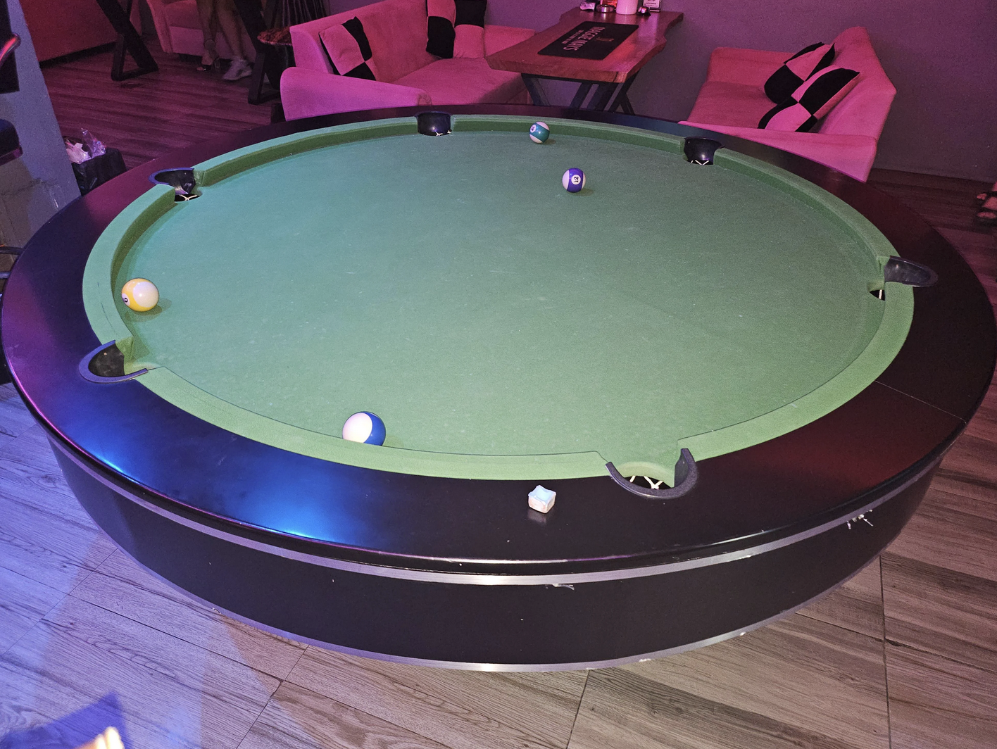 A "playable" full size pool table with six pocket that is completely round.