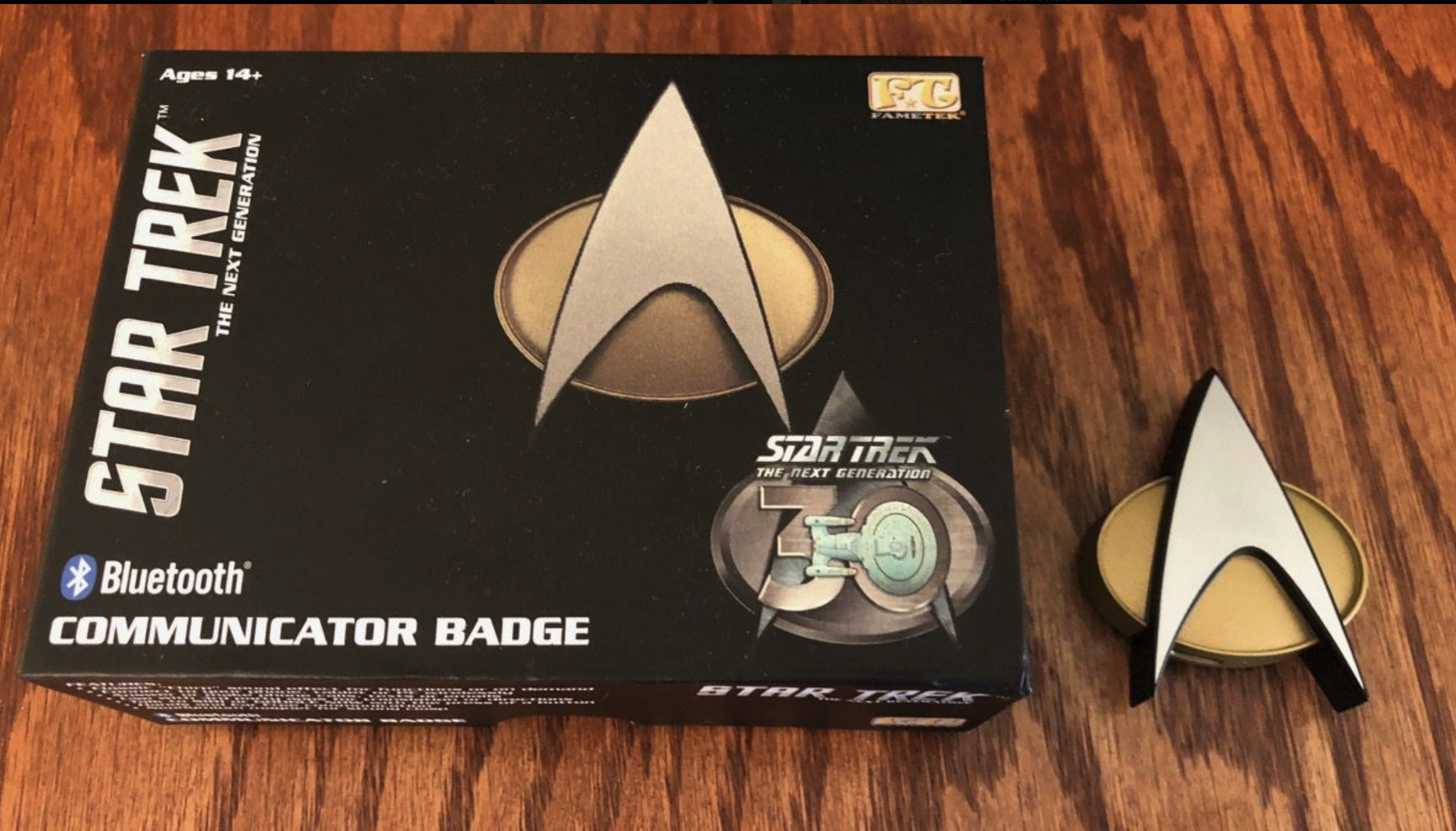 A picture of the box and the actual toy which is a Bluetooth communication badge from Star Trek the next generation.